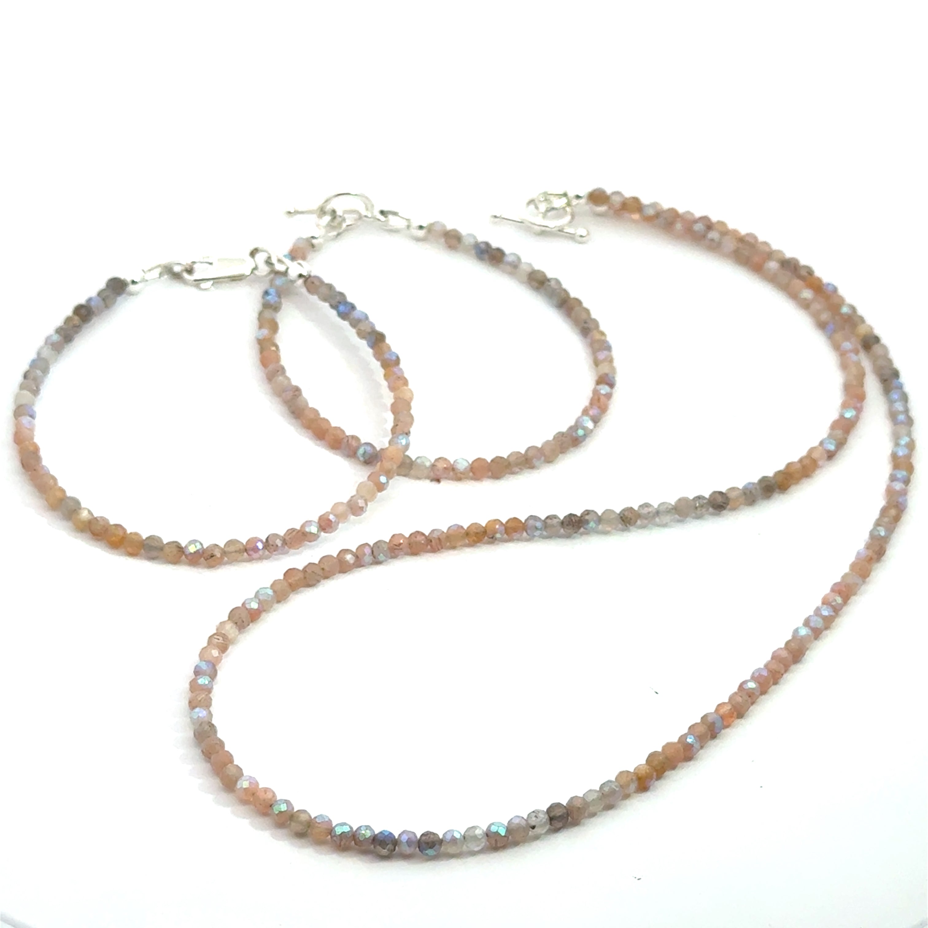 Titanium-Coated Labradorite Necklace with matching bracelets on white front over view