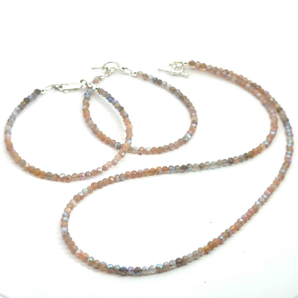 Titanium-Coated Labradorite Necklace with matching bracelets on white front over view