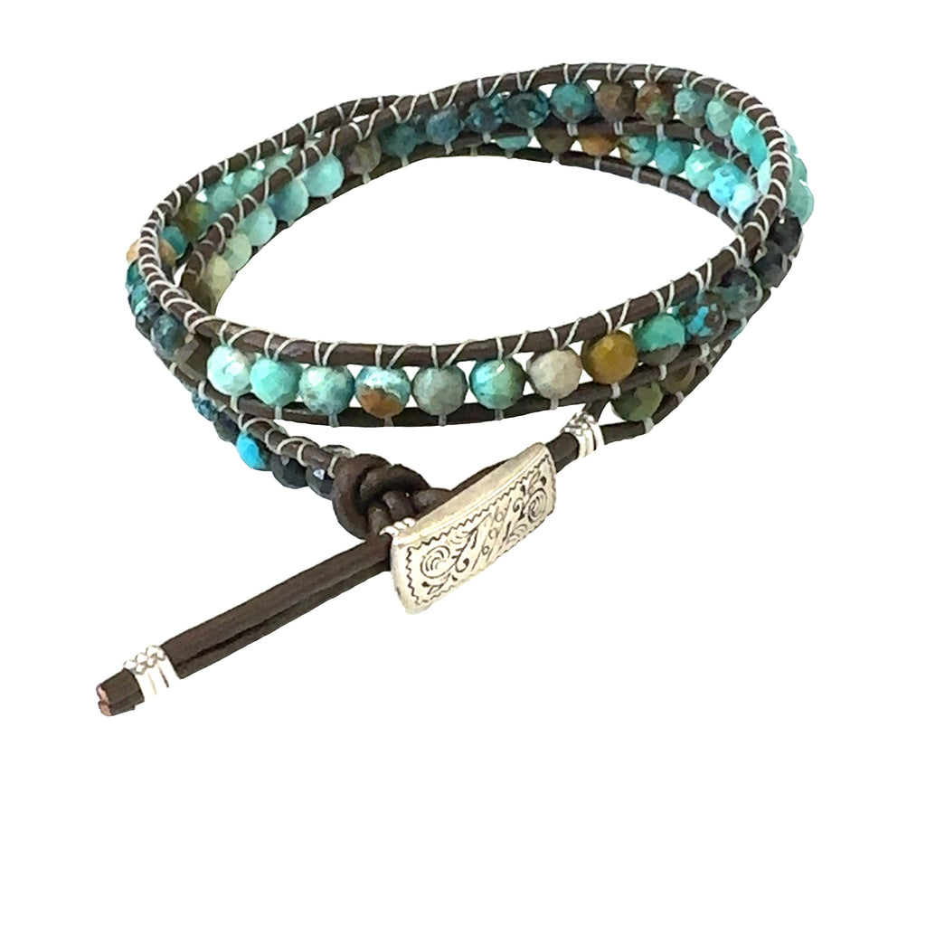 Turquoise gemstone double wrap bracelet with sterling silver findings and adjustable button slots on white back  angle overview