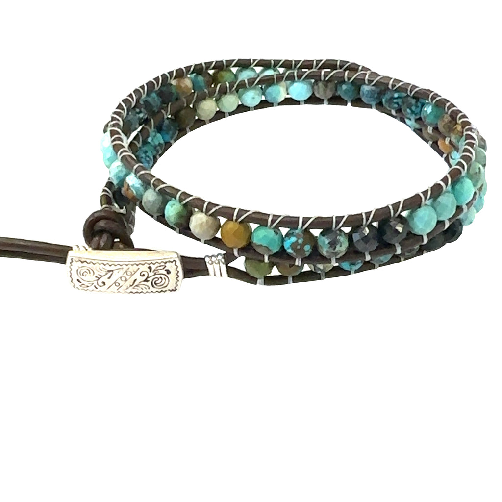 Turquoise gemstone double wrap bracelet with sterling silver findings and adjustable button slots on white left  angle overview