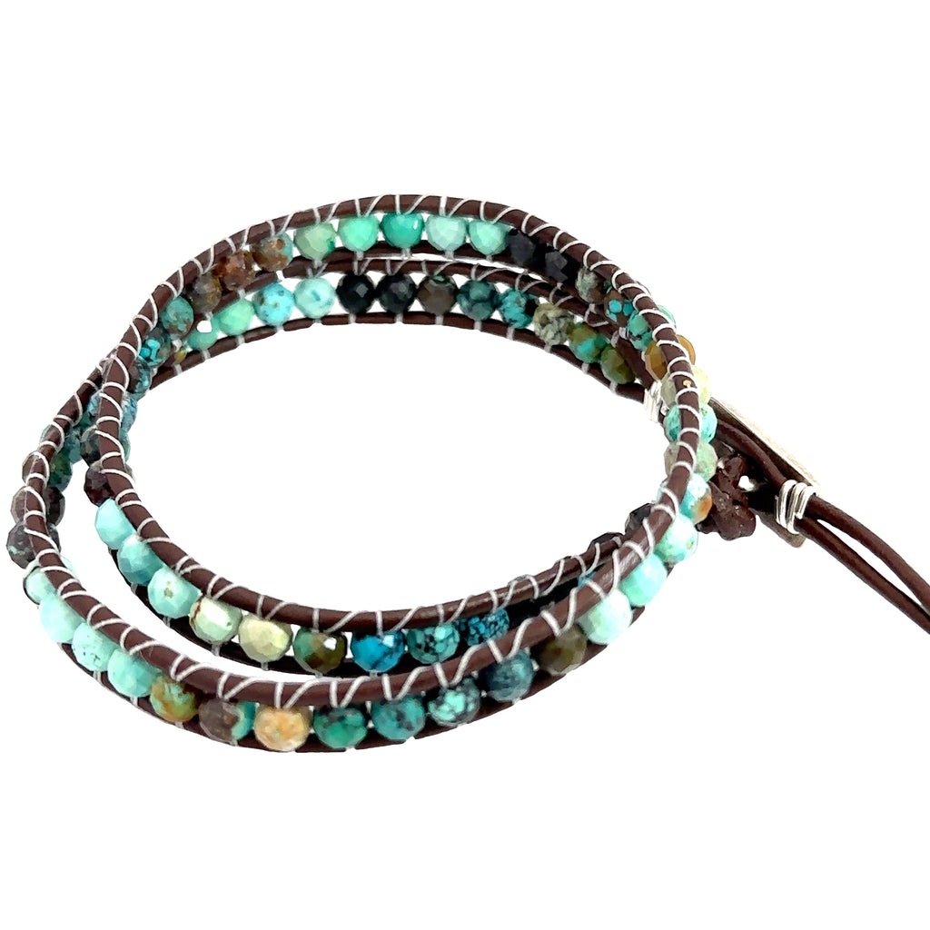 Turquoise gemstone double wrap bracelet with sterling silver findings and adjustable button slots on white left side overview