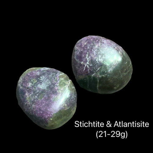 Two Atlantisite stones on a black background with text indicating weight range (21-29g), front view. 