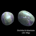 Two Atlantisite stones on a black background with text indicating weight range (30-49g), front view. 