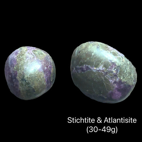 Two Atlantisite stones on a black background with text indicating weight range (30-49g), front view. 