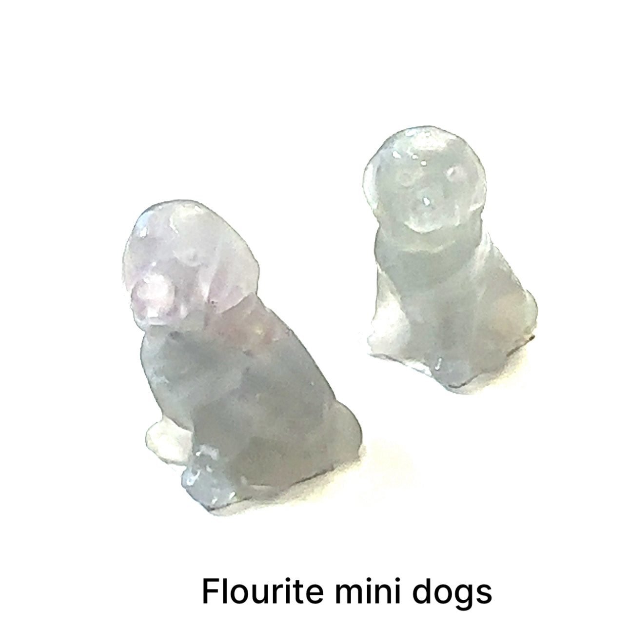 Two fluorite mini hound Dog gemstone carving on white background, front view.