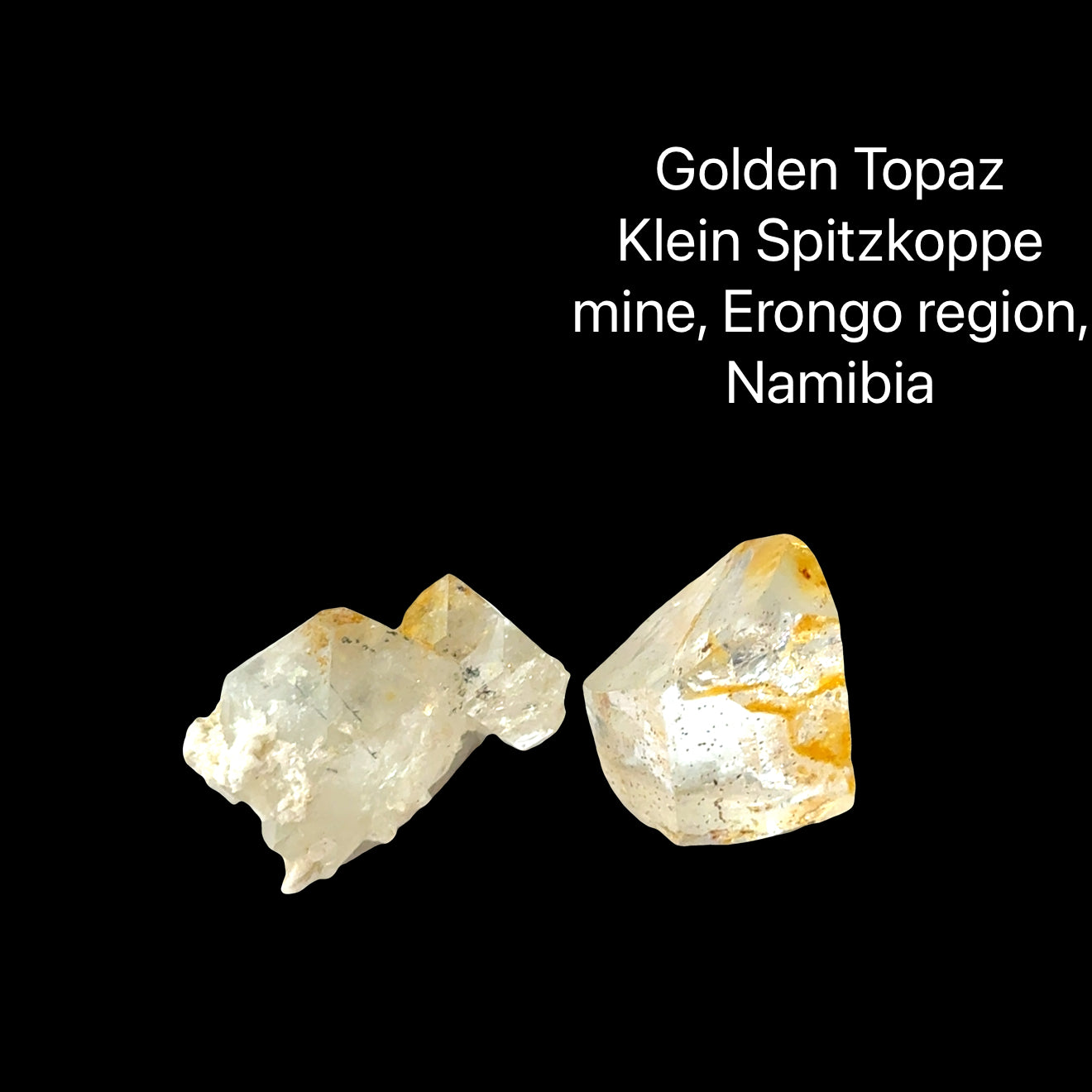 Two rough golden topaz crystals on a black background with text indicating their origin (4.3-4.4g), front View.