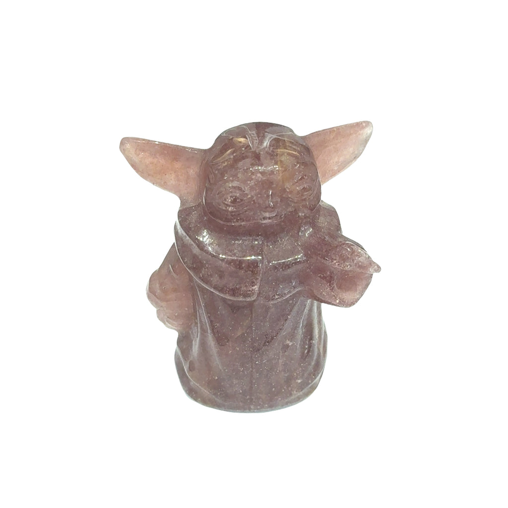 A small carved figurine of Grogu, also known as The Child, made from a translucent dusty rose quartz stone, set against a plain white background.