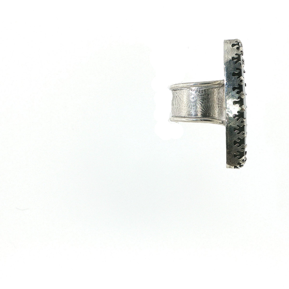 A silver-toned textured ring with a flat, wide band and a flat back, shown against a plain white background.
