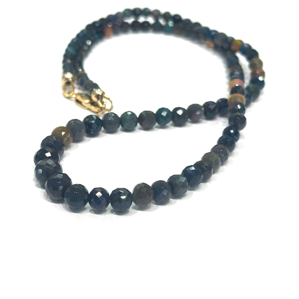 Unique Ethiopian Black Opal jewelry with faceted beads and healing properties on white angle view