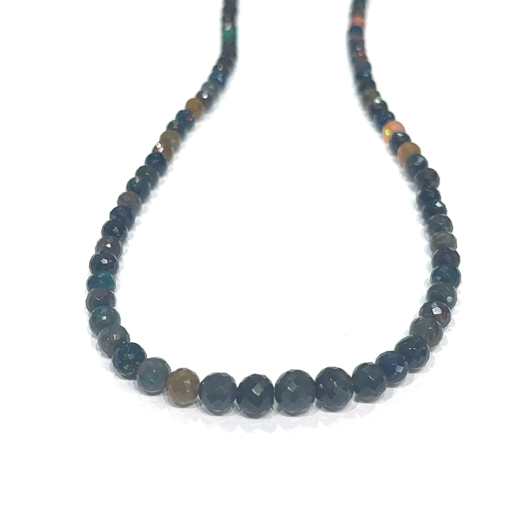 Unique Ethiopian Black Opal jewelry with faceted beads and healing properties on white hanging view