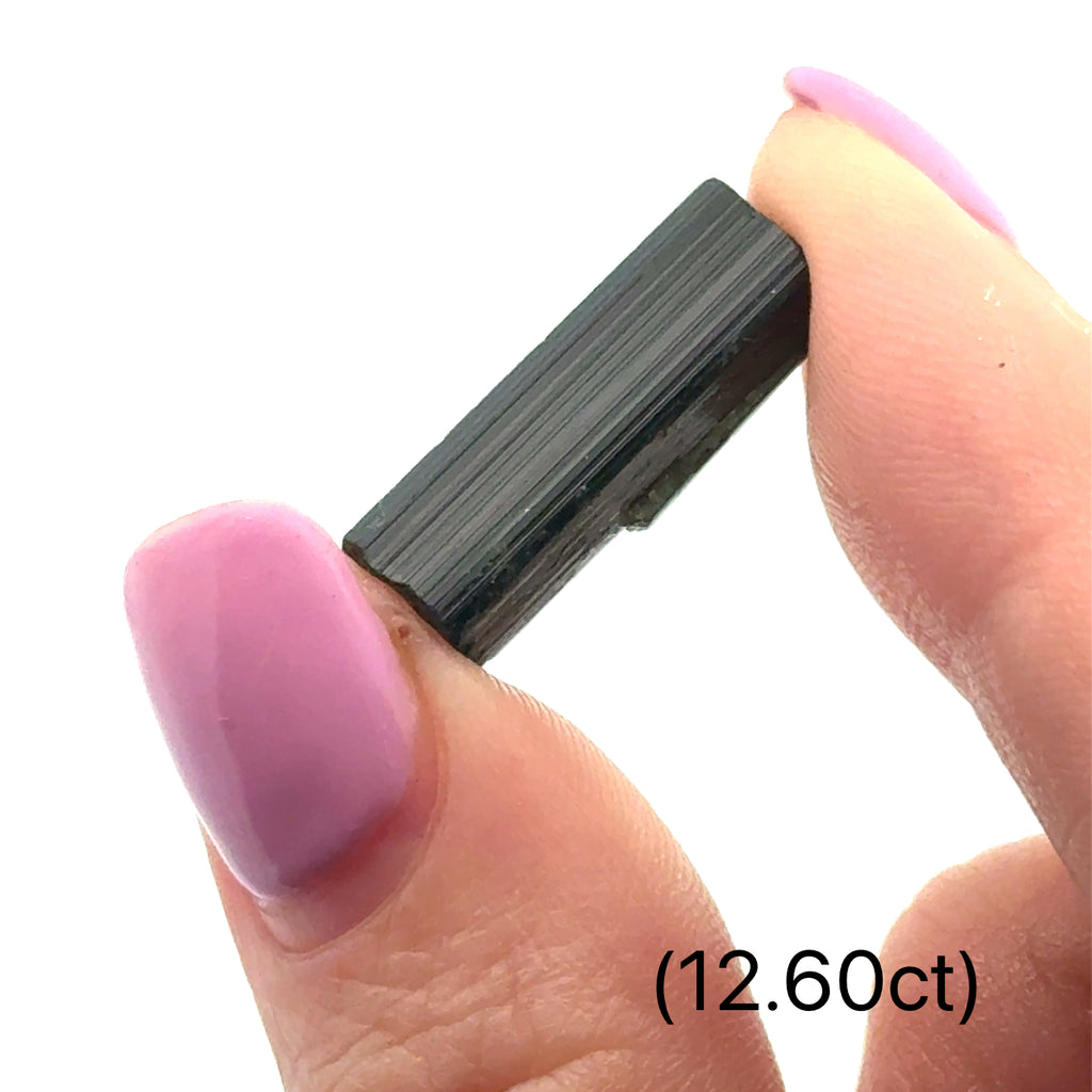 Unique Green Tourmaline gemstone for meditation and spiritual growth (12.60ct) on white and in finger tips front view