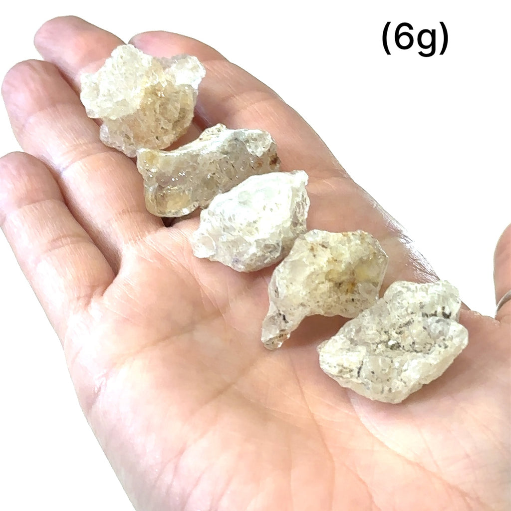 Unique Hyalite Opal gemstone for meditation and spiritual clarity grouping of (6g) on white in hand for overview