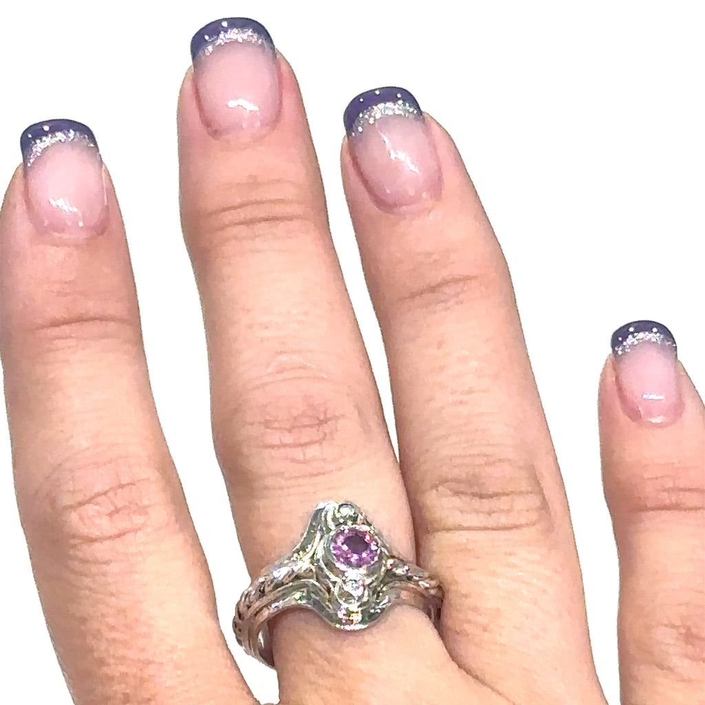 Unique Pink Sapphire and diamond sterling silver ring with rope design detailing on white on ring finger view