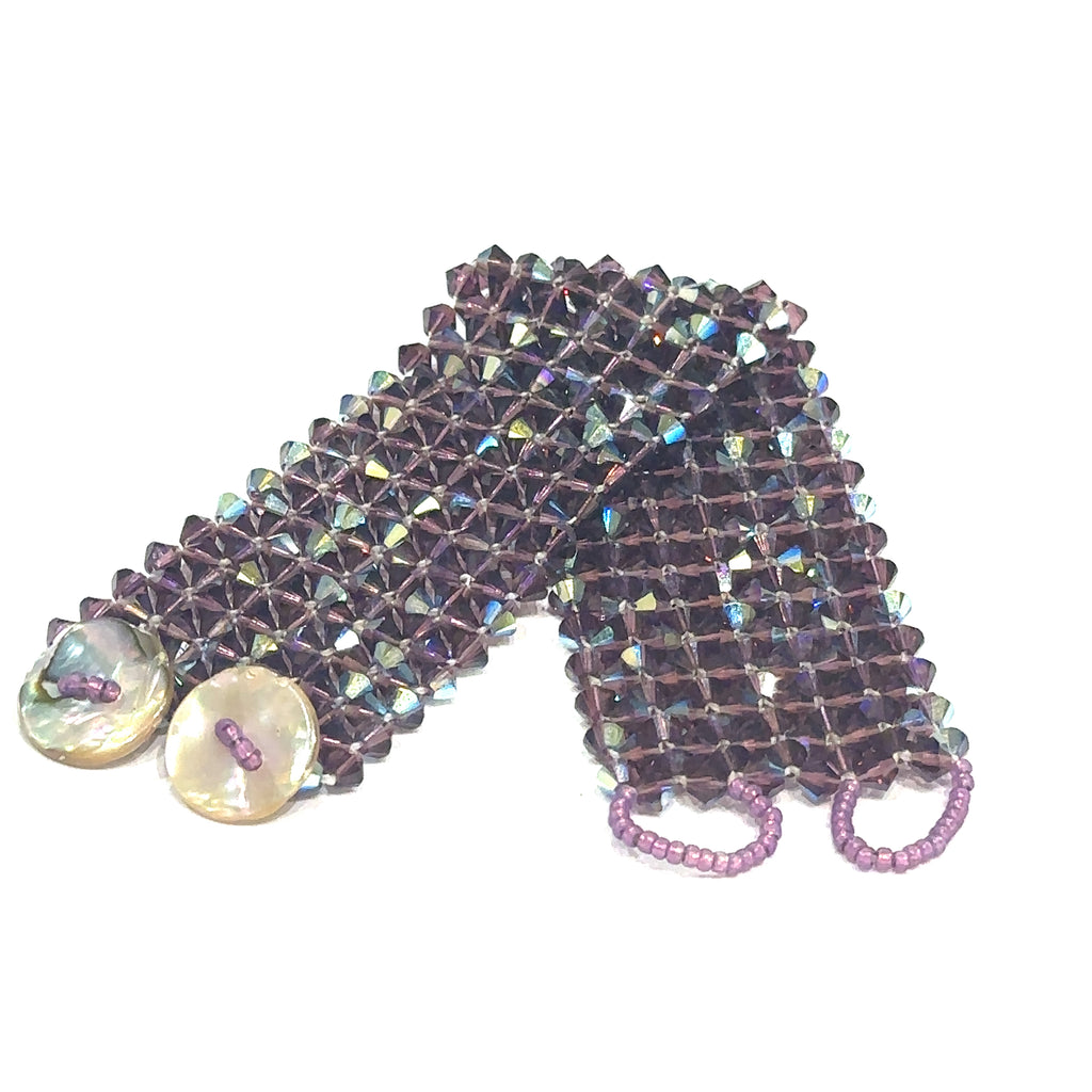 Unique Swarovski crystal bracelet with 400 faceted purple bicone beads in right‑angle weave on white flat center view 