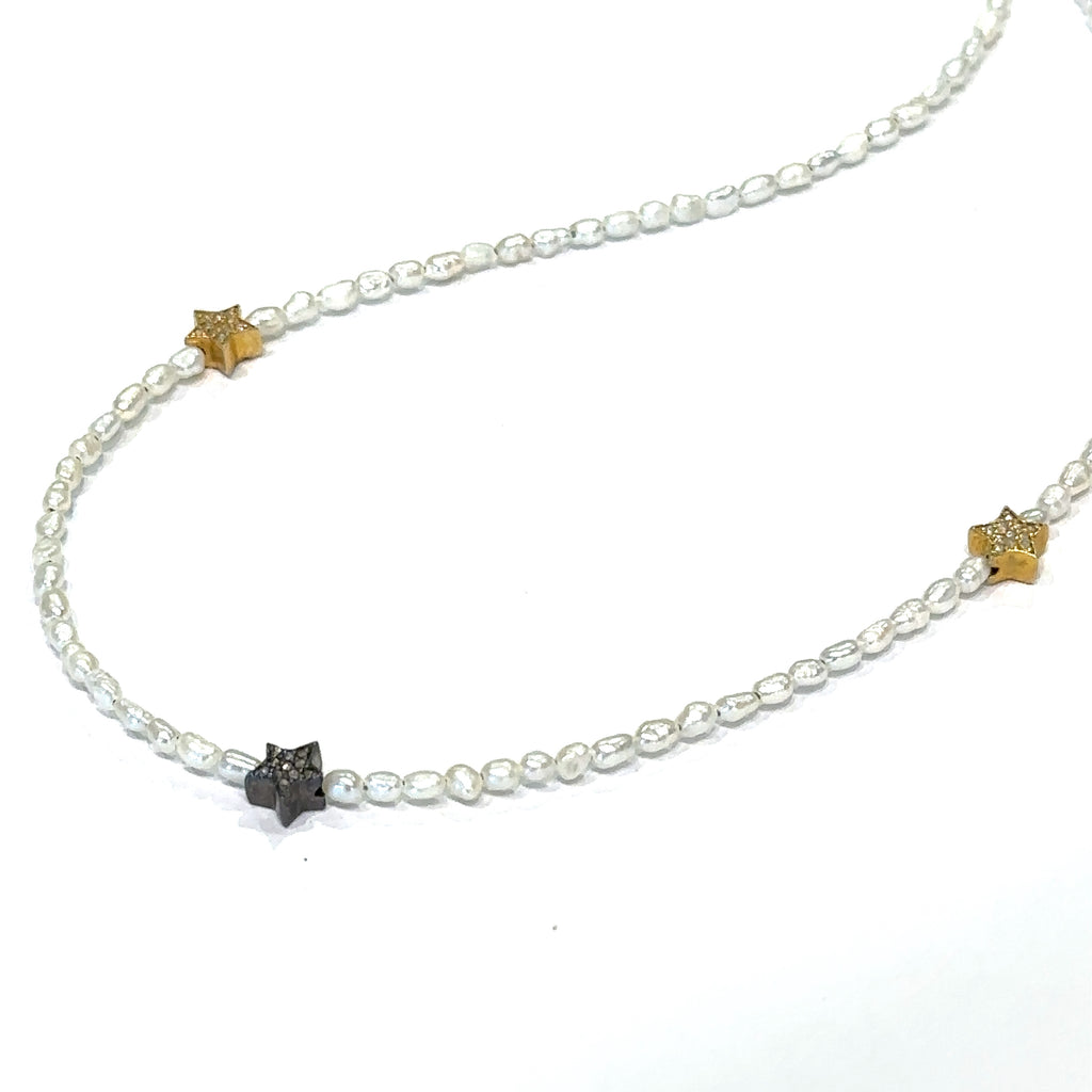 Unique pearl collarbone necklace featuring star charms on white long view