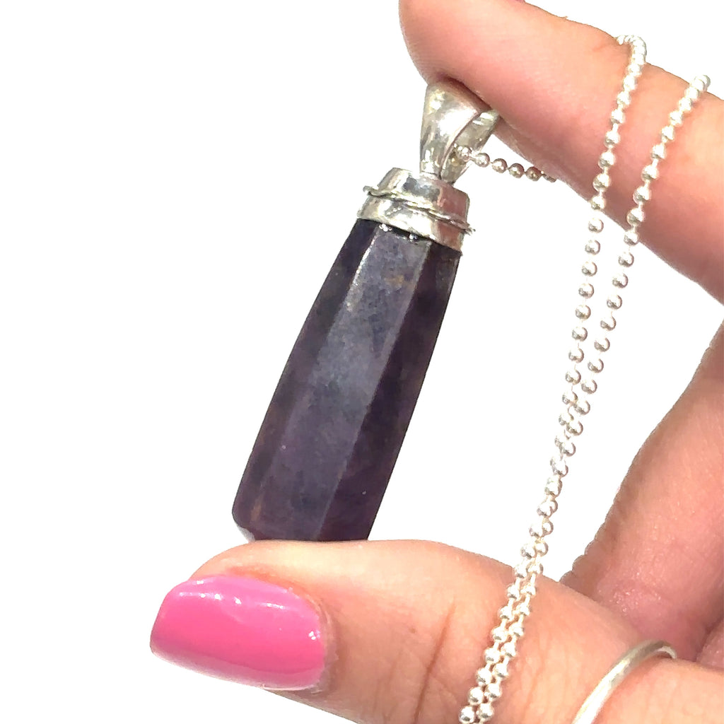 Unique ruby crystal point pendant necklace with sterling silver rope chain on white and in finger tips overview