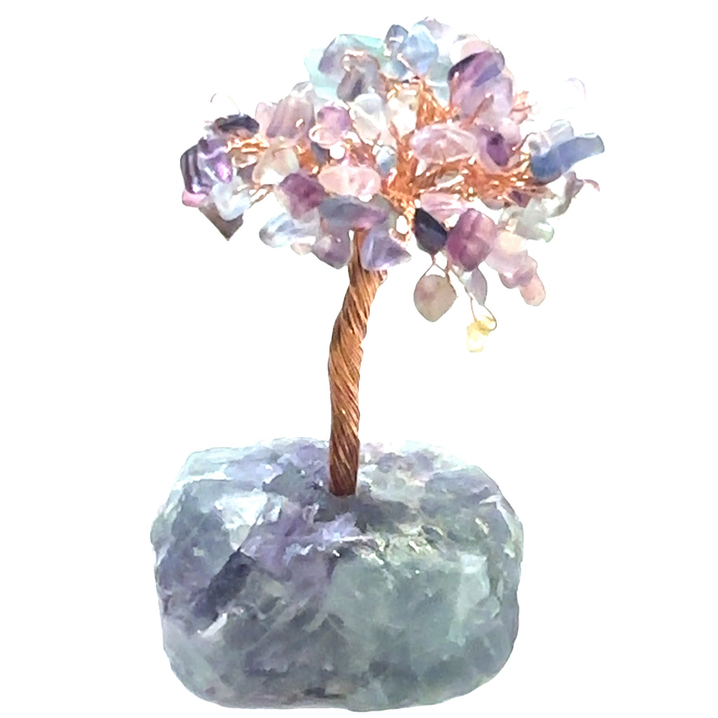 Watermelon Tourmaline Gemstone tree placed on an altar for home décor and energy healing. On a white background, front view.