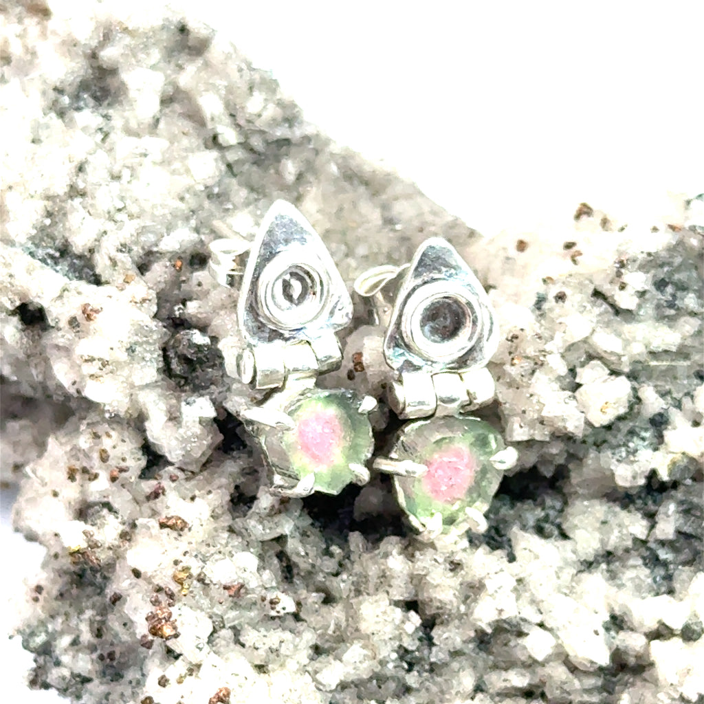 Watermelon Tourmaline Slice Earrings on white and rock up close front view 