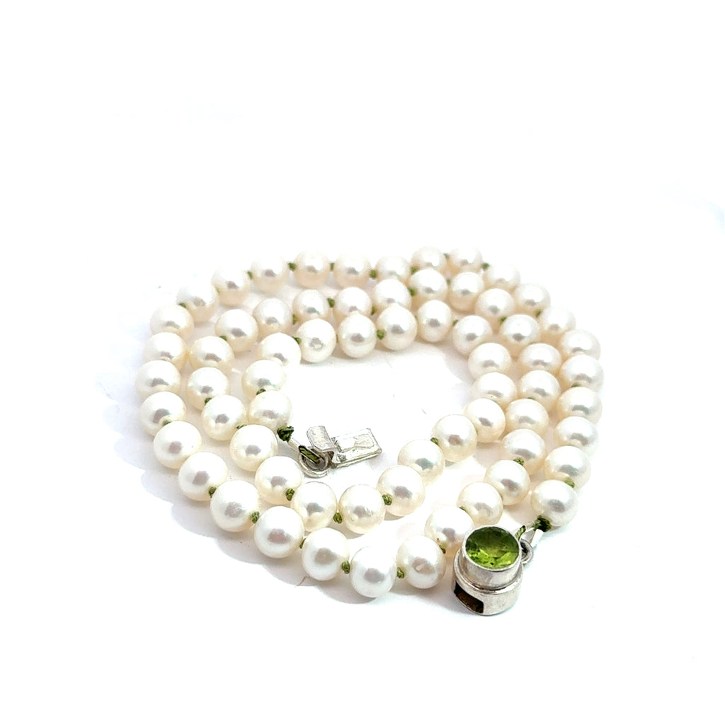 White Freshwater Pearl Necklace on white bottom up spiral close up view