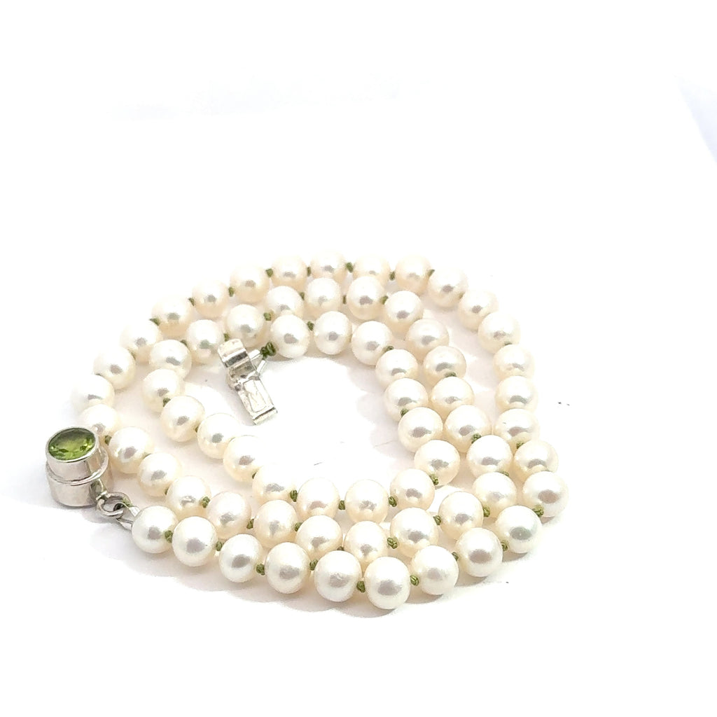 White Freshwater Pearl Necklace on white left side up spiral close up view