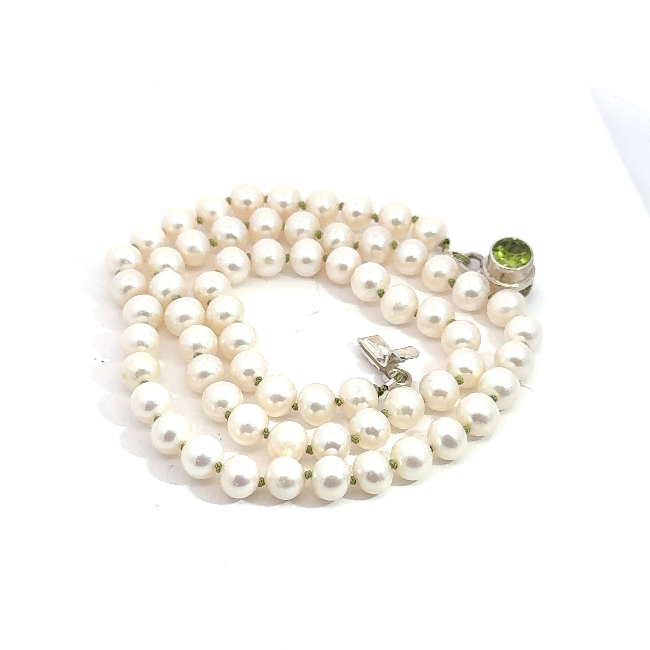 White Freshwater Pearl Necklace on white side up spiral close up view