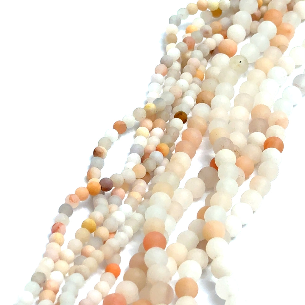 White and Peach Aventurine gemstone strands displaying two different sizes on a white background, overview. 