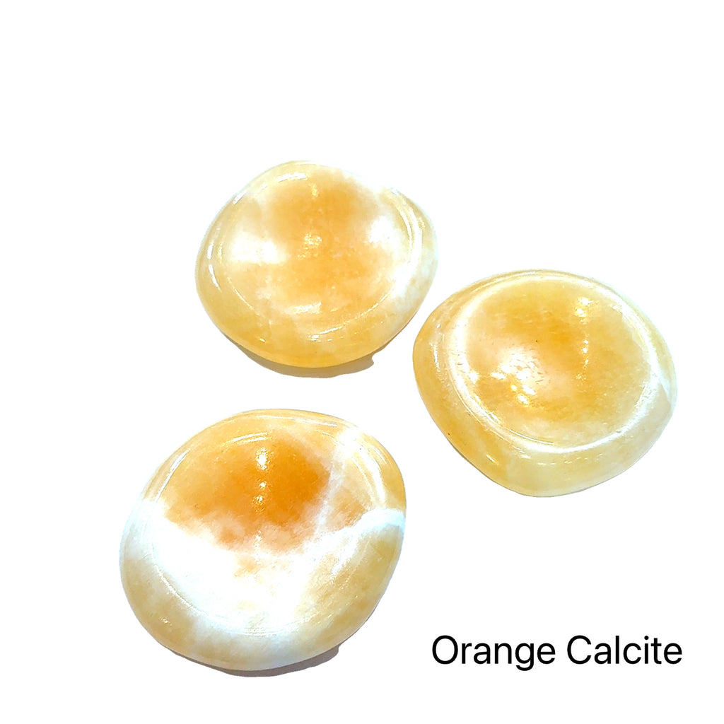 Worry Stone grouping of orange calcite  on white front view