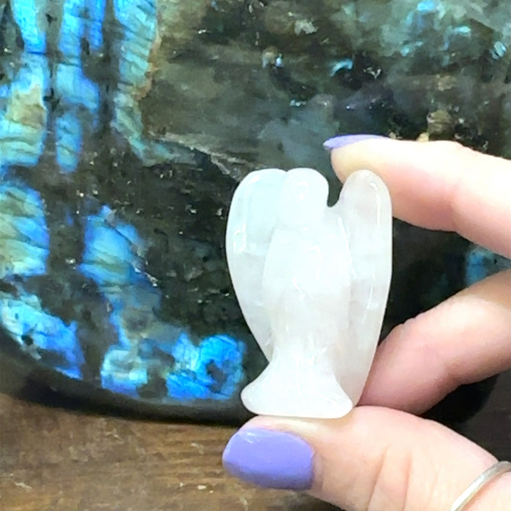 Carved gemstone angel figurine made from Rose Quartz for compassion and harmony  on white front view