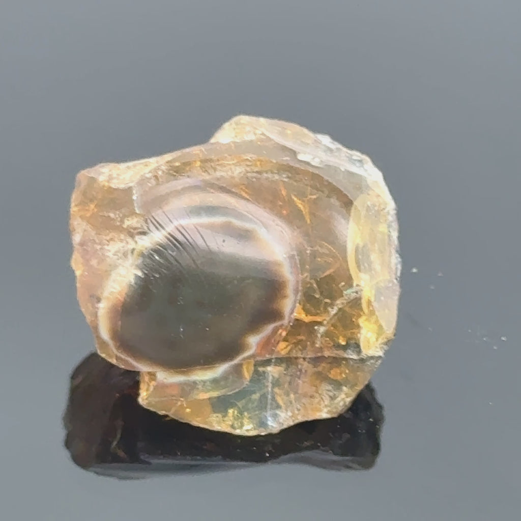 A raw Ethiopian opal gemstones with varying colors, displayed on a white background, video