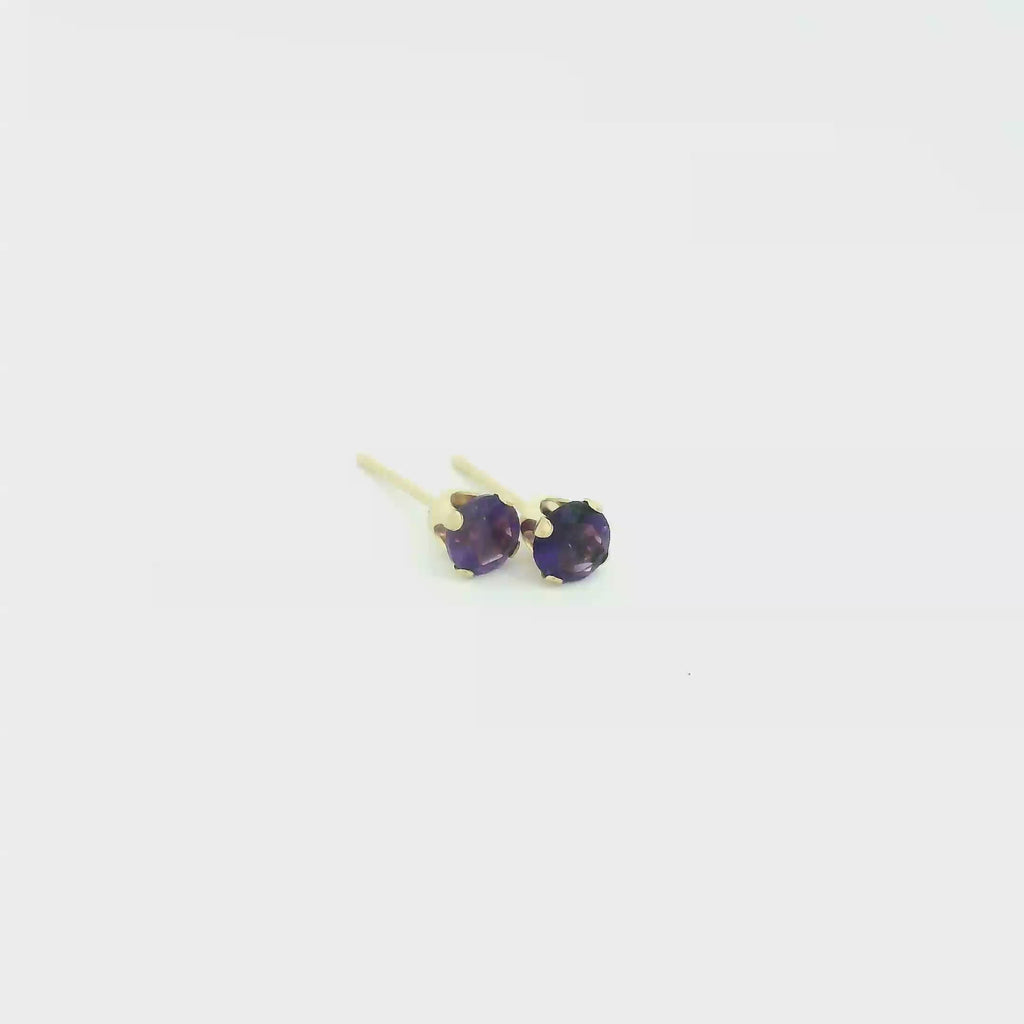 14k gold amethyst post earrings with deep purple round faceted gemstones on white background front overview video