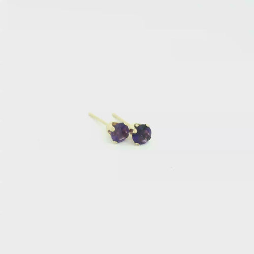 14k gold amethyst post earrings with deep purple round faceted gemstones on white background front overview video