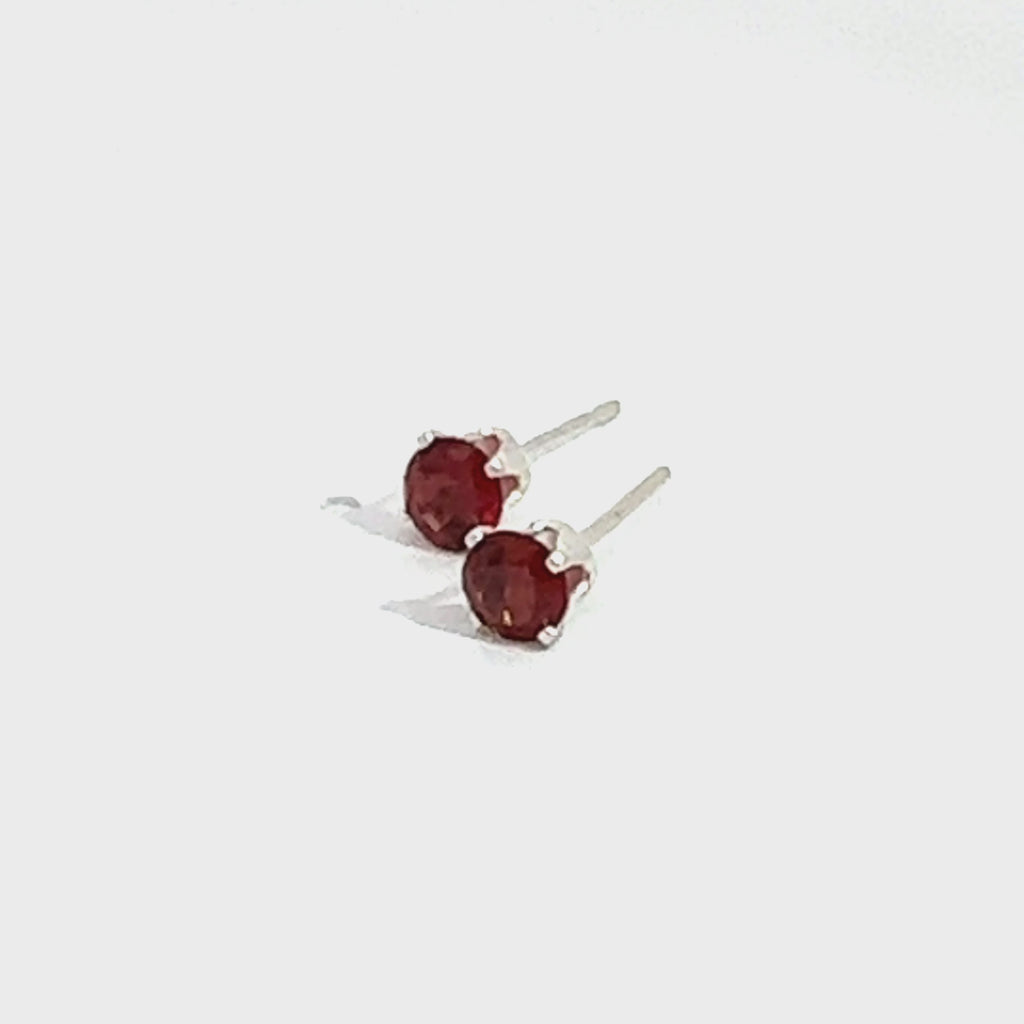 Faceted 4mm Garnet Post Earrings in Sterling Silver  Basket Setting 4 prong on white front left angled overview video