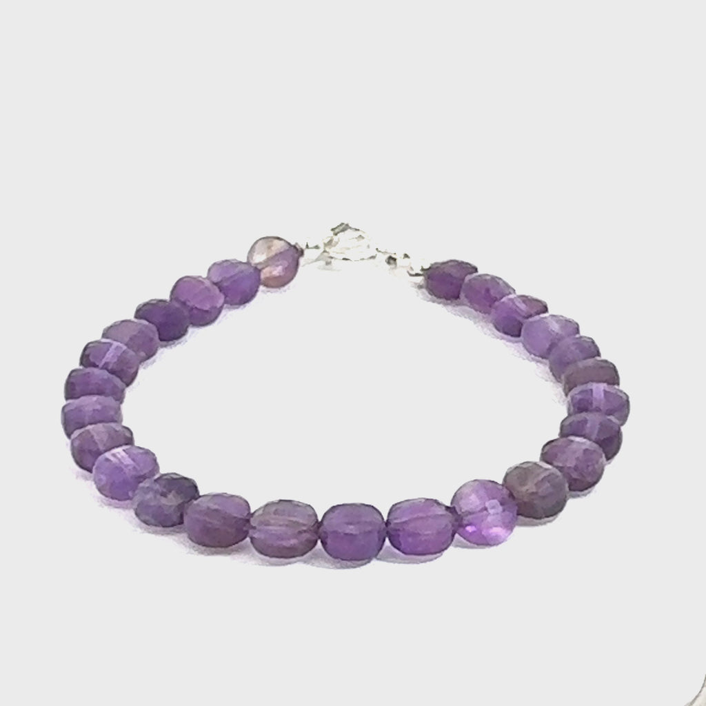 A beaded faceted coin Amethyst gemstone bracelets, displayed against a white background, front close up overview. (toggle) video