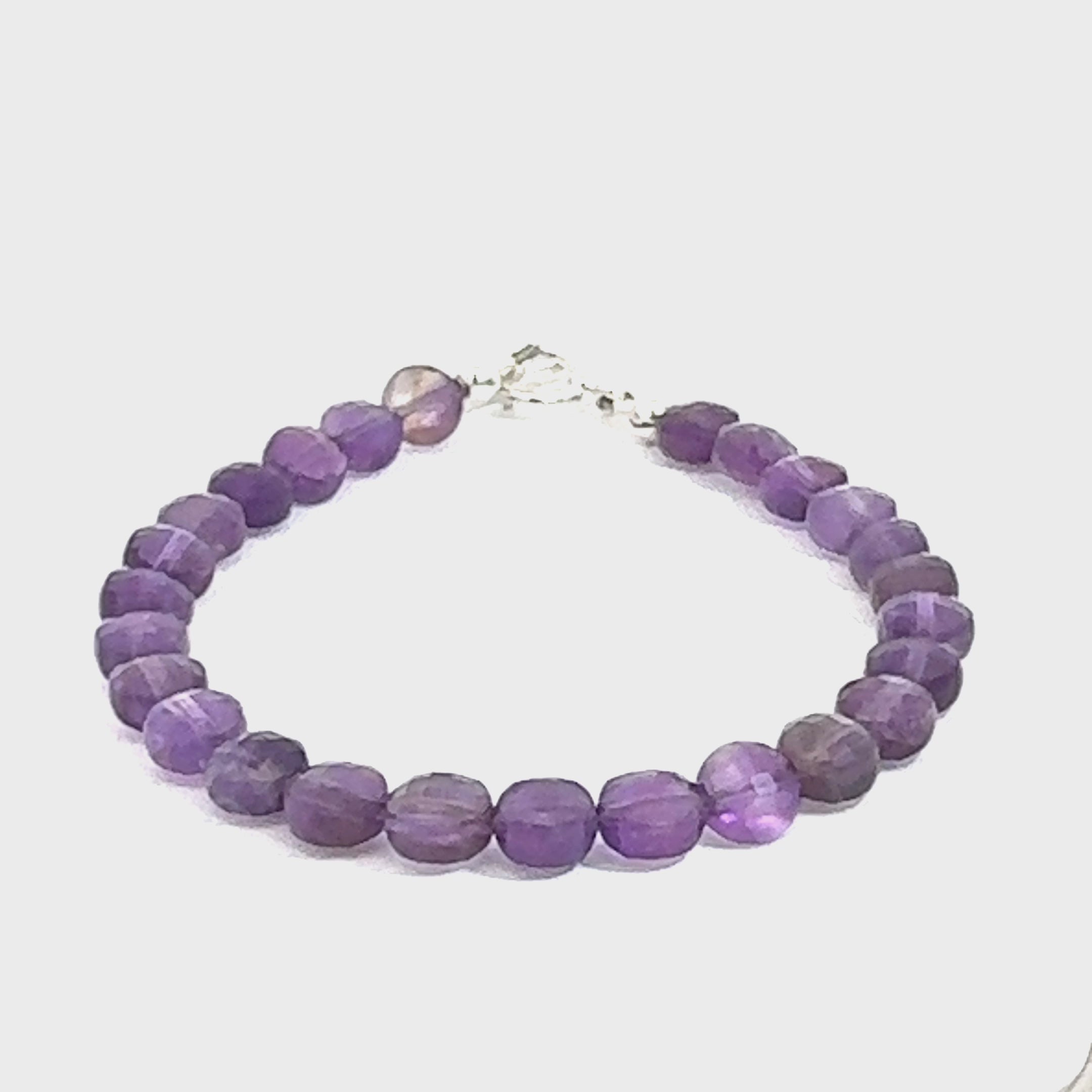 A beaded faceted coin Amethyst gemstone bracelets, displayed against a white background, front close up overview. (toggle) video