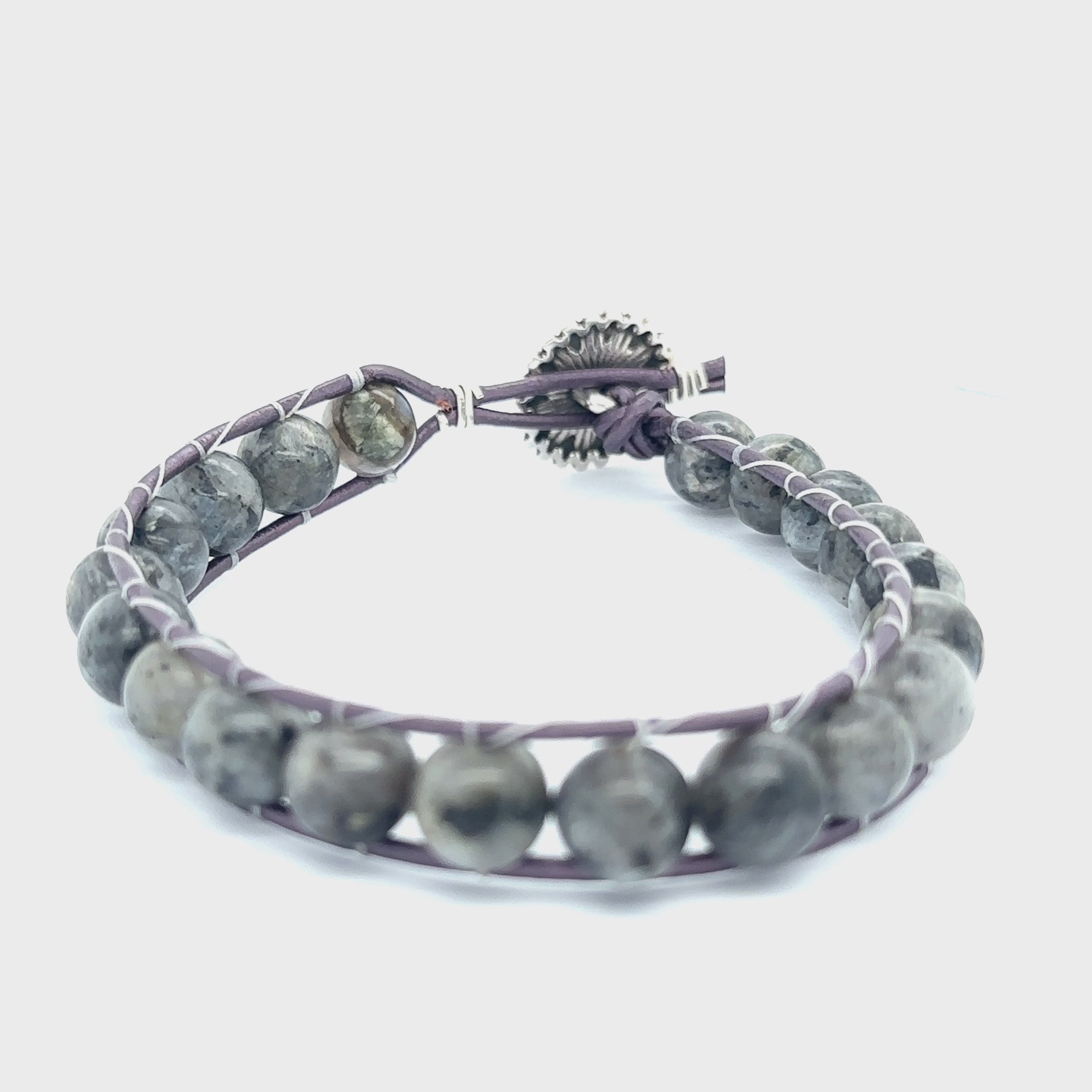 Larvikite (Labradorite) gemstone leather wrap bracelet with silver sunflower button, 7 inches long on white back overview video