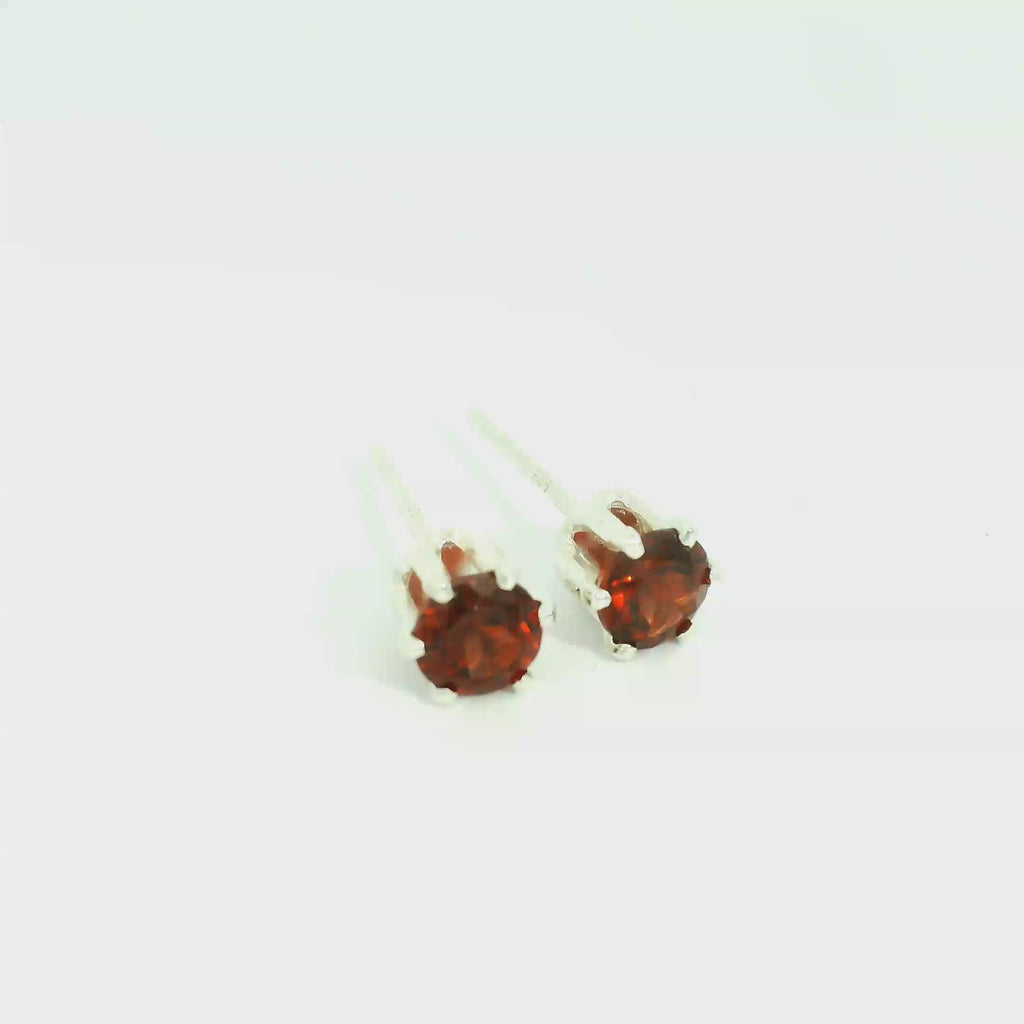 Faceted 4mm Garnet Post Earrings in Sterling Silver  Basket Setting six prong on white front side overview