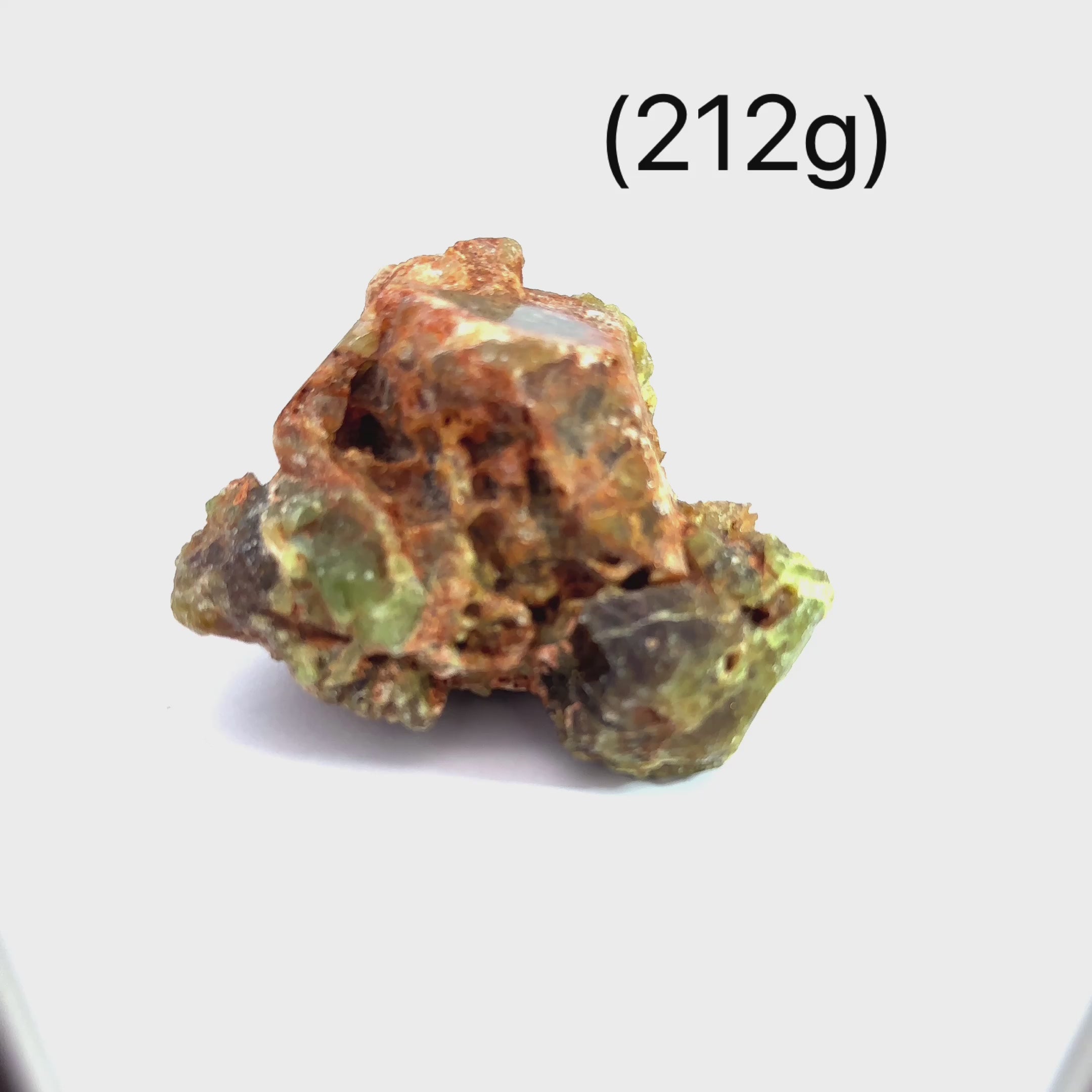 Raw Green Dermatoid Garnet Gemstone  grouping on white (212g) overview video