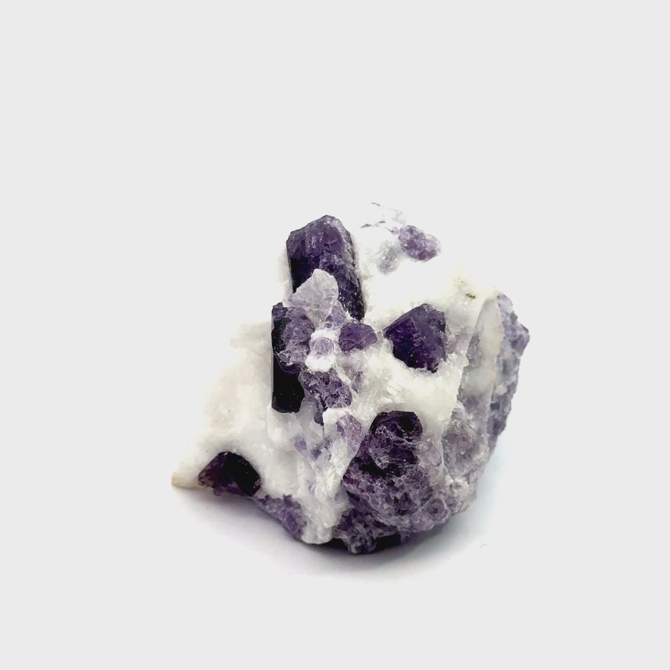 Purple Scapolite Gemstone 92.7g on white front view video