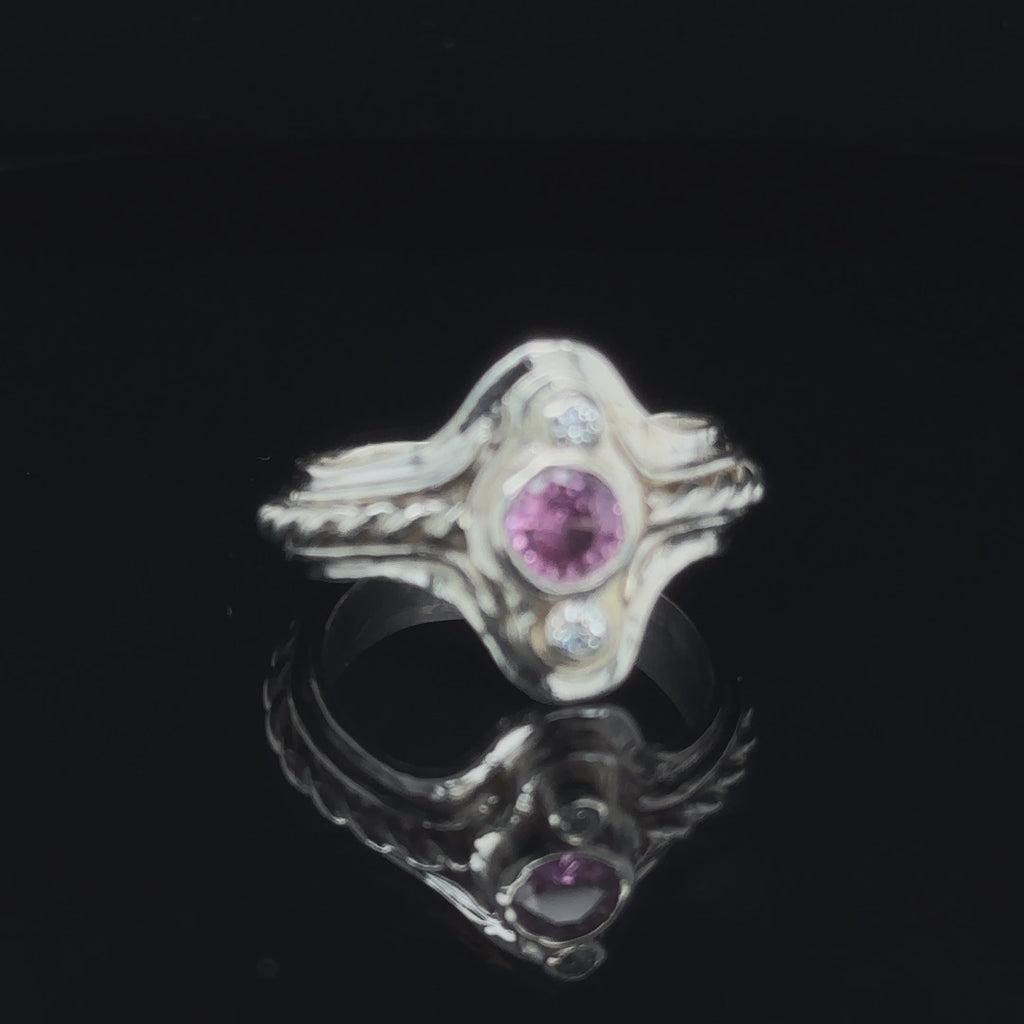 Hand‑forged sterling silver step ring with 5.4mm Pink Sapphire and two bezel‑set diamonds, size 7.5 on black close-up view video