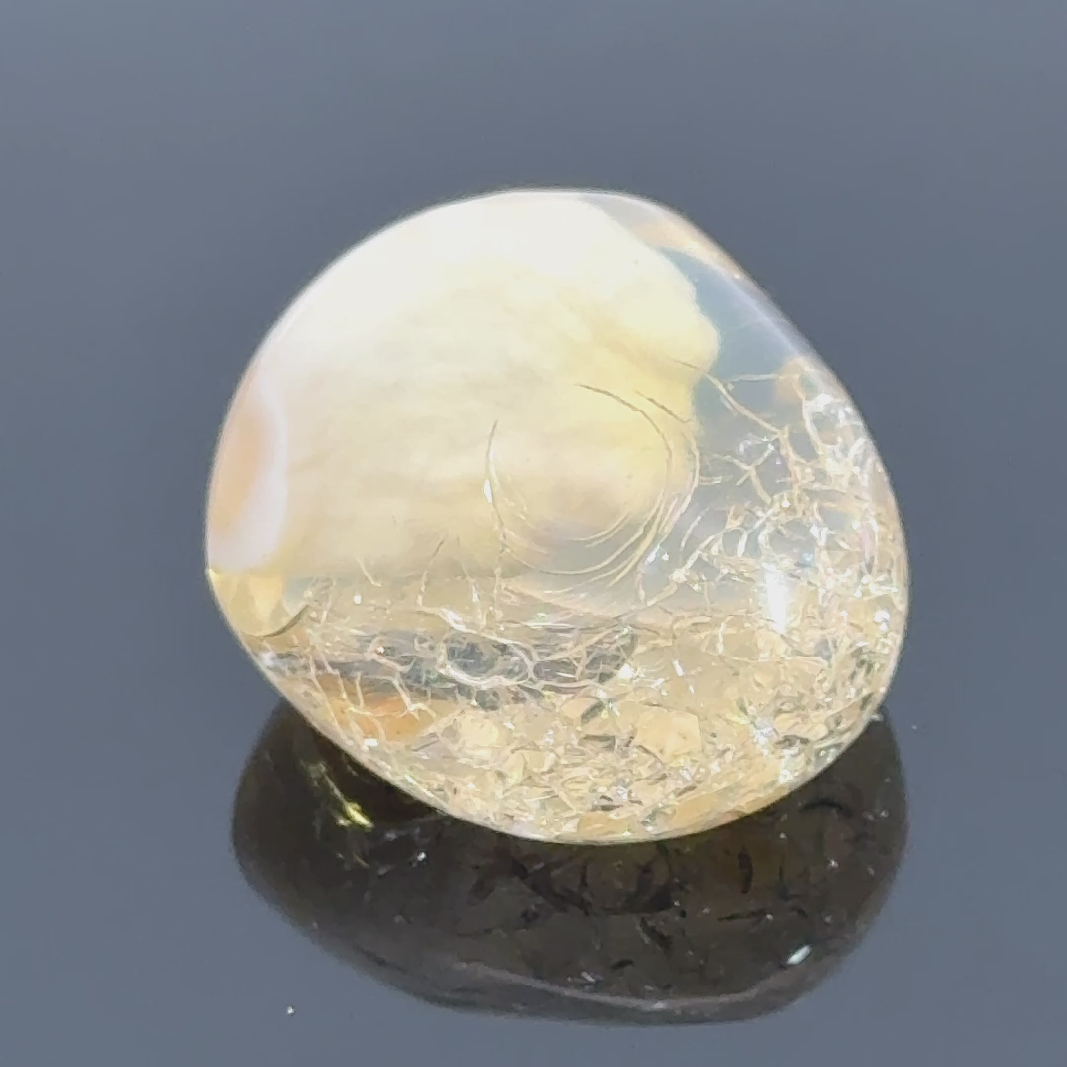 A raw Ethiopian opal gemstones with varying colors, displayed on a white background, video