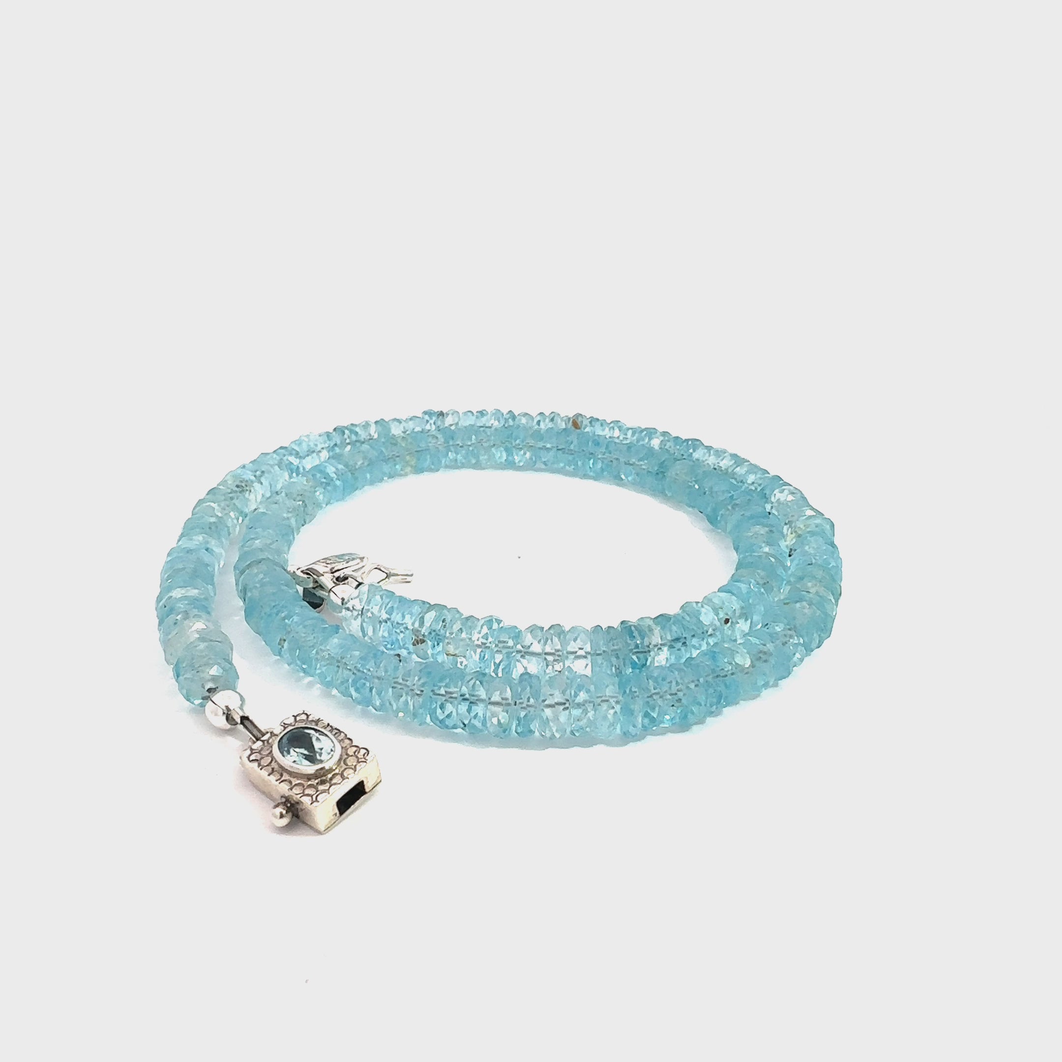 Blue Topaz Gemstone Necklace  on white front spiral overview video