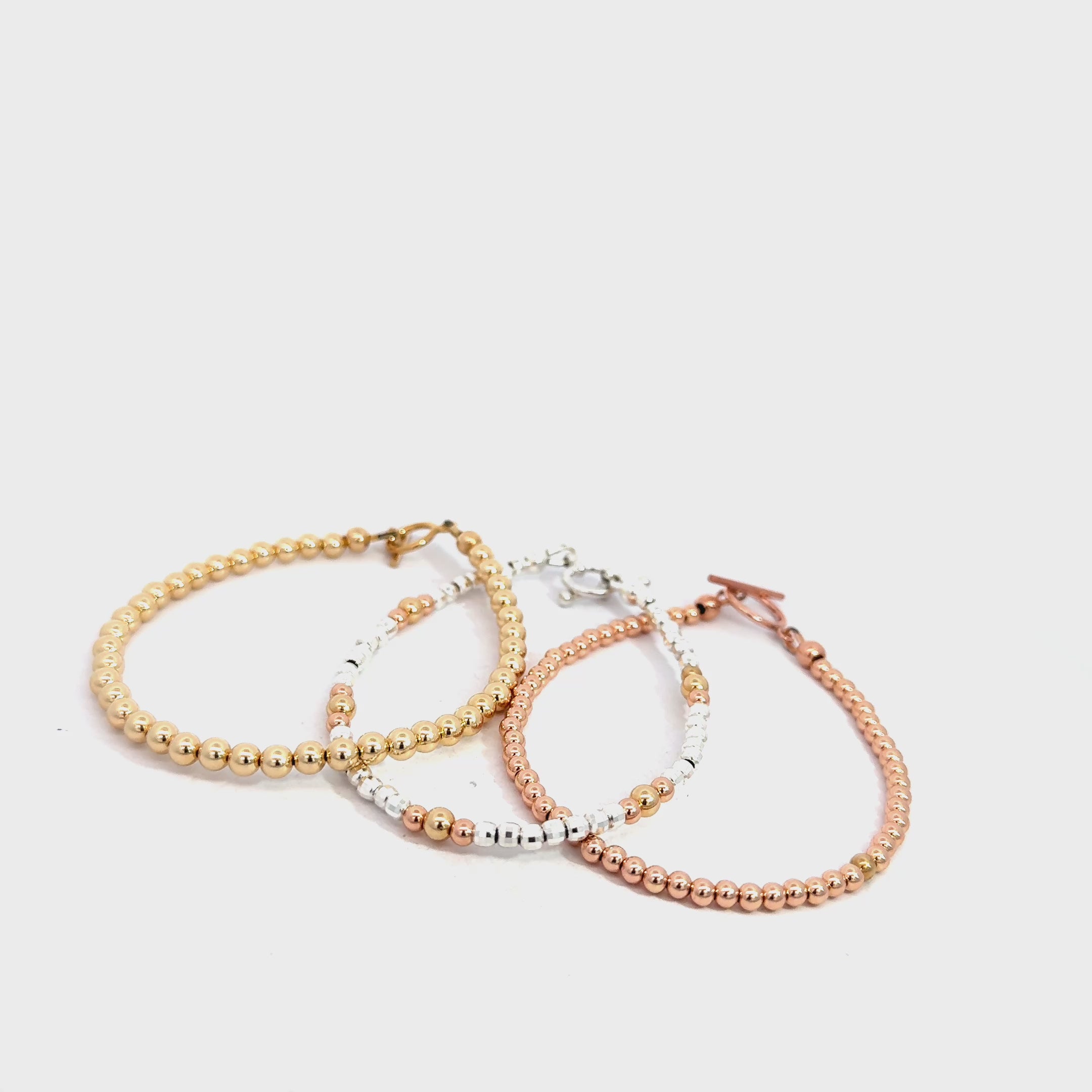 Gold, Rose Gold & Silver Faceted Bead Bracelet grouping on white front overview video