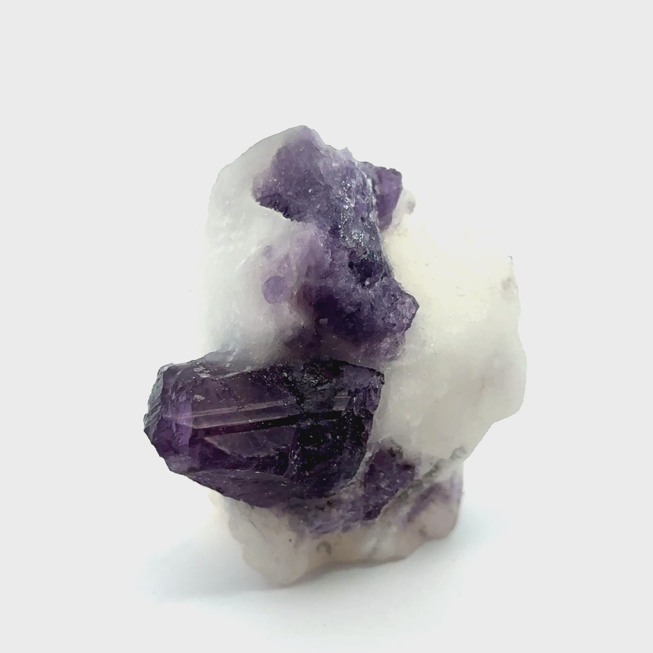 Purple Scapolite Gemstone 61.5g on white front view video
