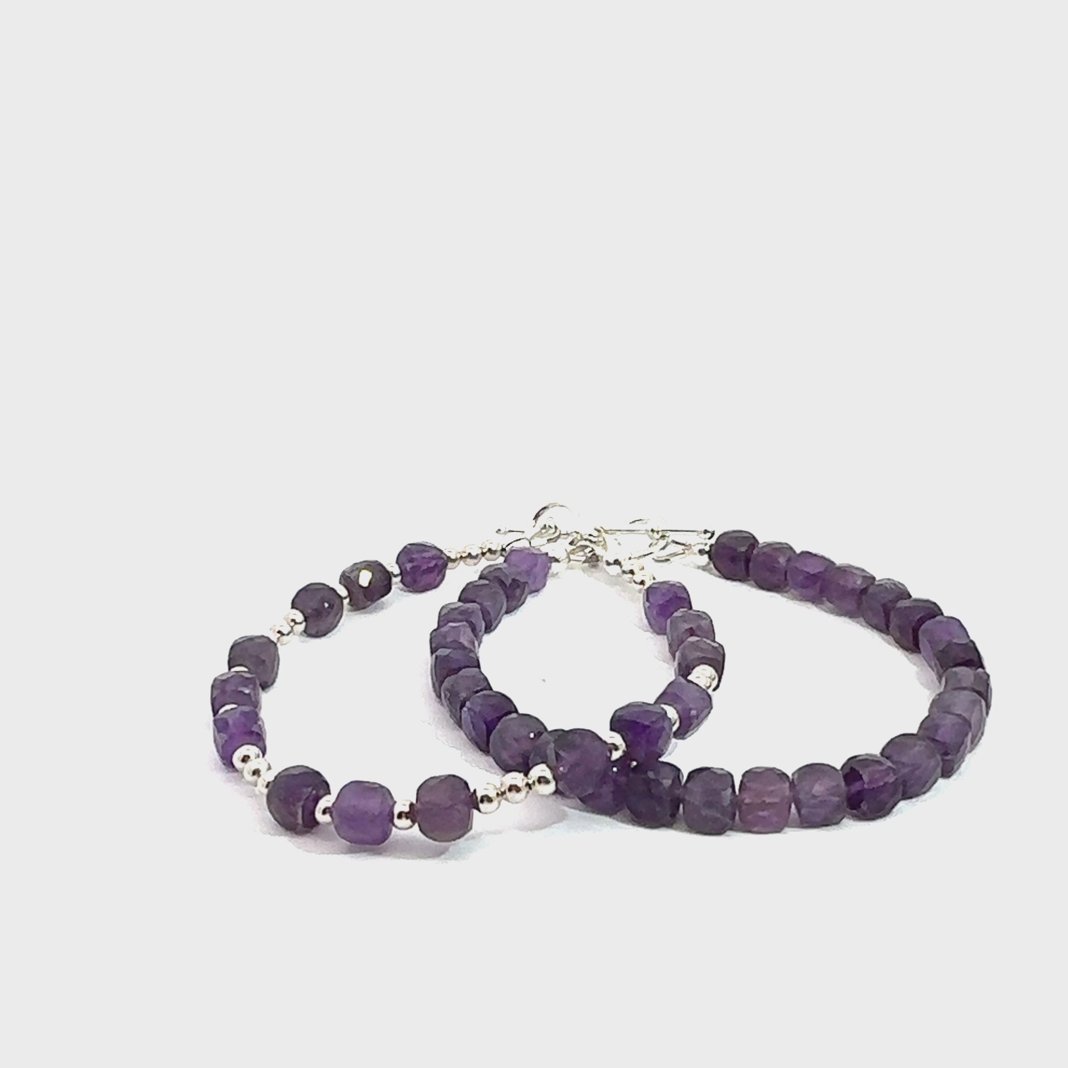 Two beaded gemstone bracelets with Amethyst stones and silver accents, displayed against a white background, front overview. video