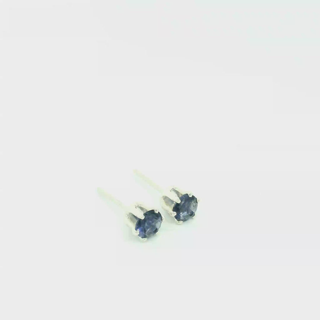 A pair of sterling silver basket stud earrings with round blue iolite gemstones, showing the front view with pushbacks and an overview. video