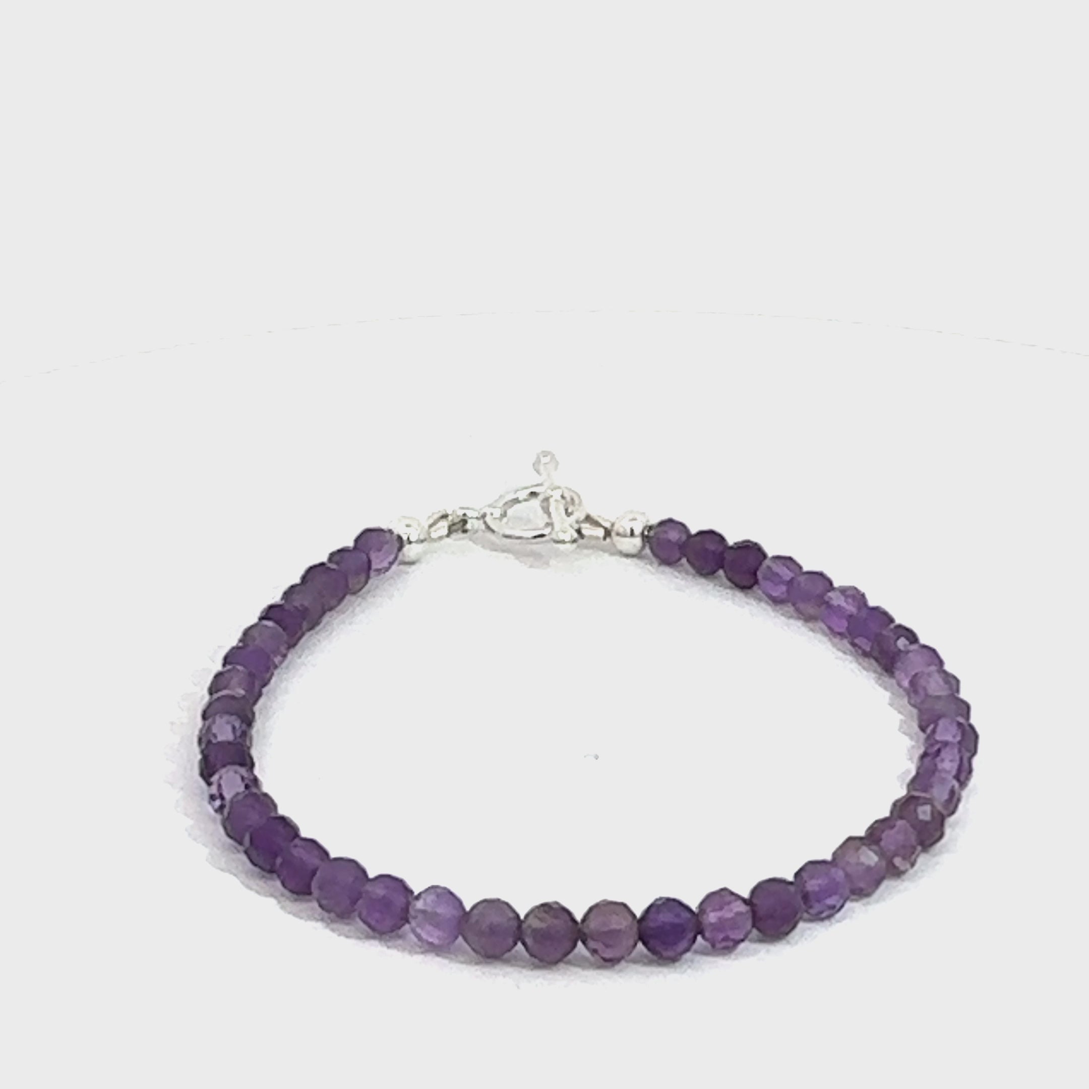A beaded 3mm faceted  Amethyst gemstone bracelets, displayed against a white background, front close up overview. (toggle) video
