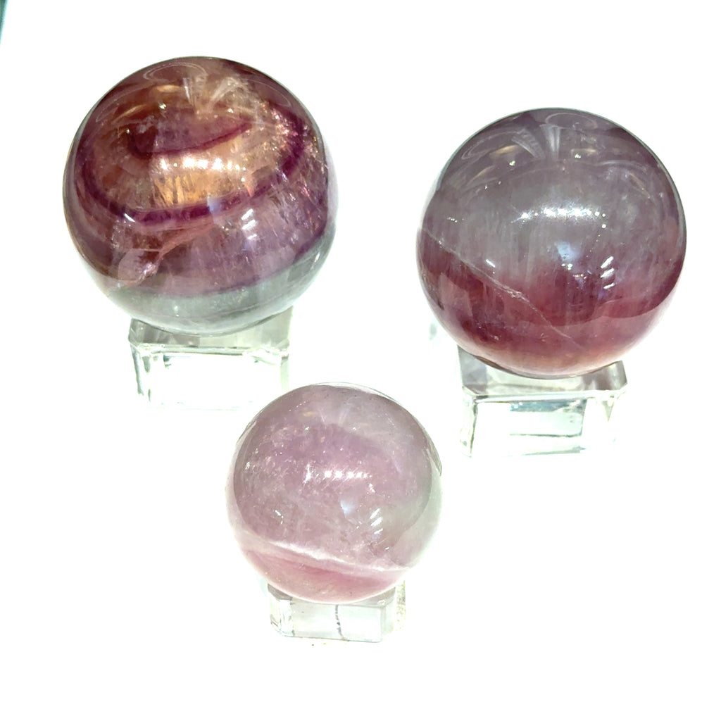 rainbow fluorite gemstone sphere on white grouping view 