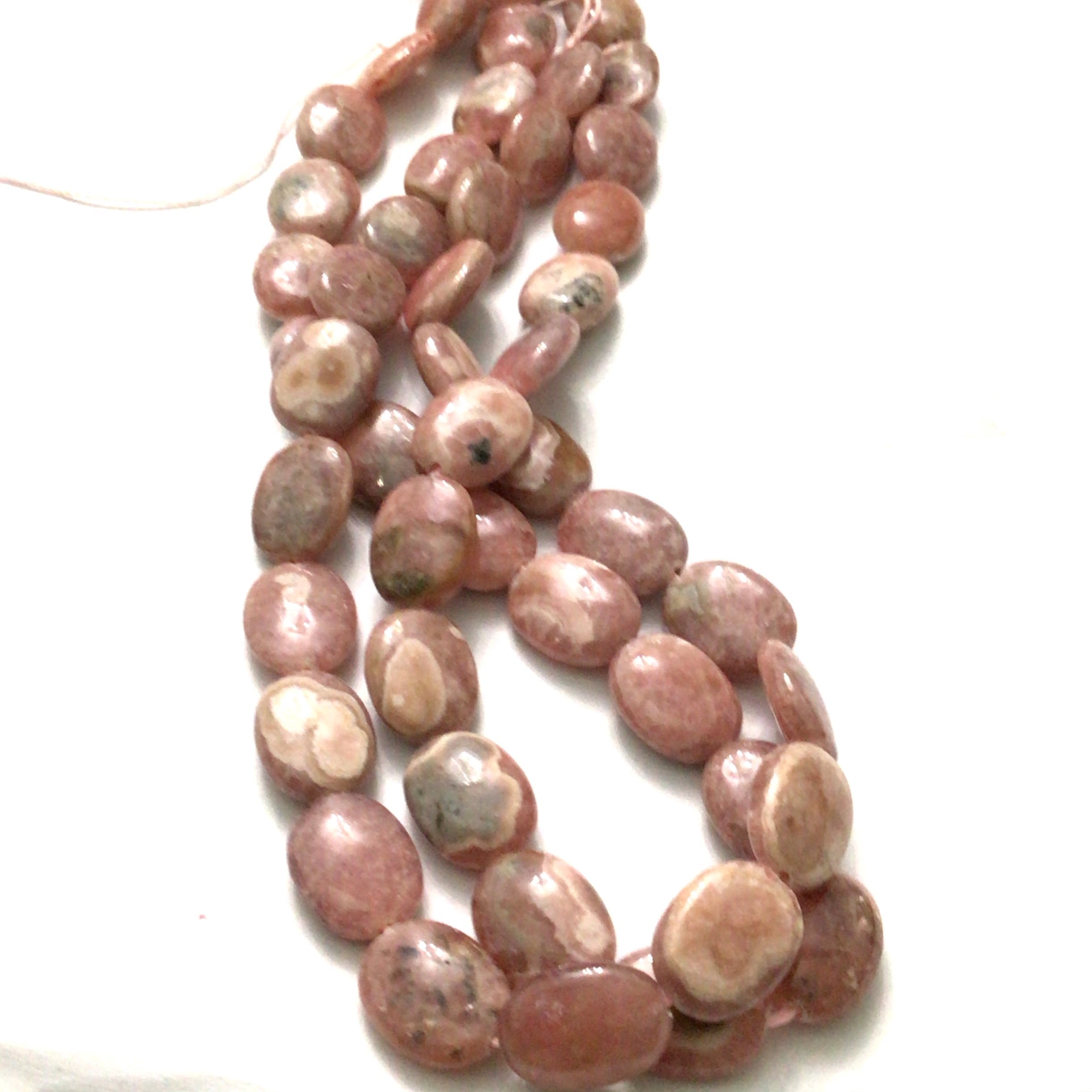 10x14mm mm Rhodochrosite smooth ovals gemstone strand on a white background, front  close up overview.