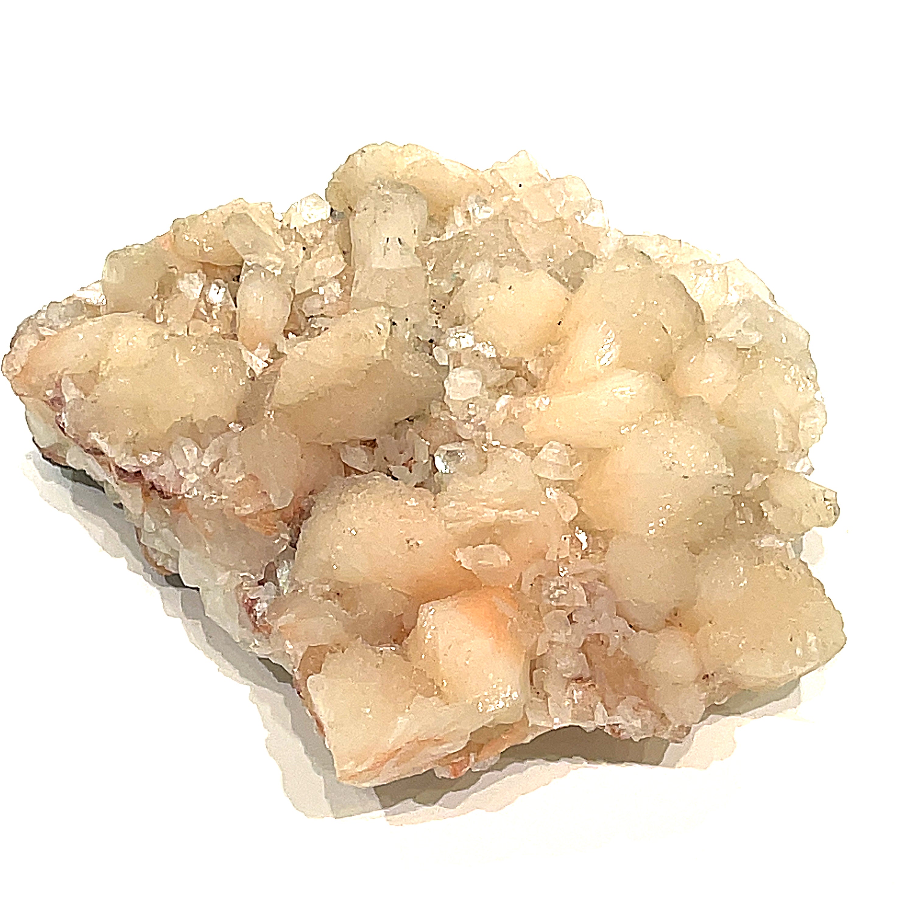 #12 Peach Stilbite on a white background, front view.