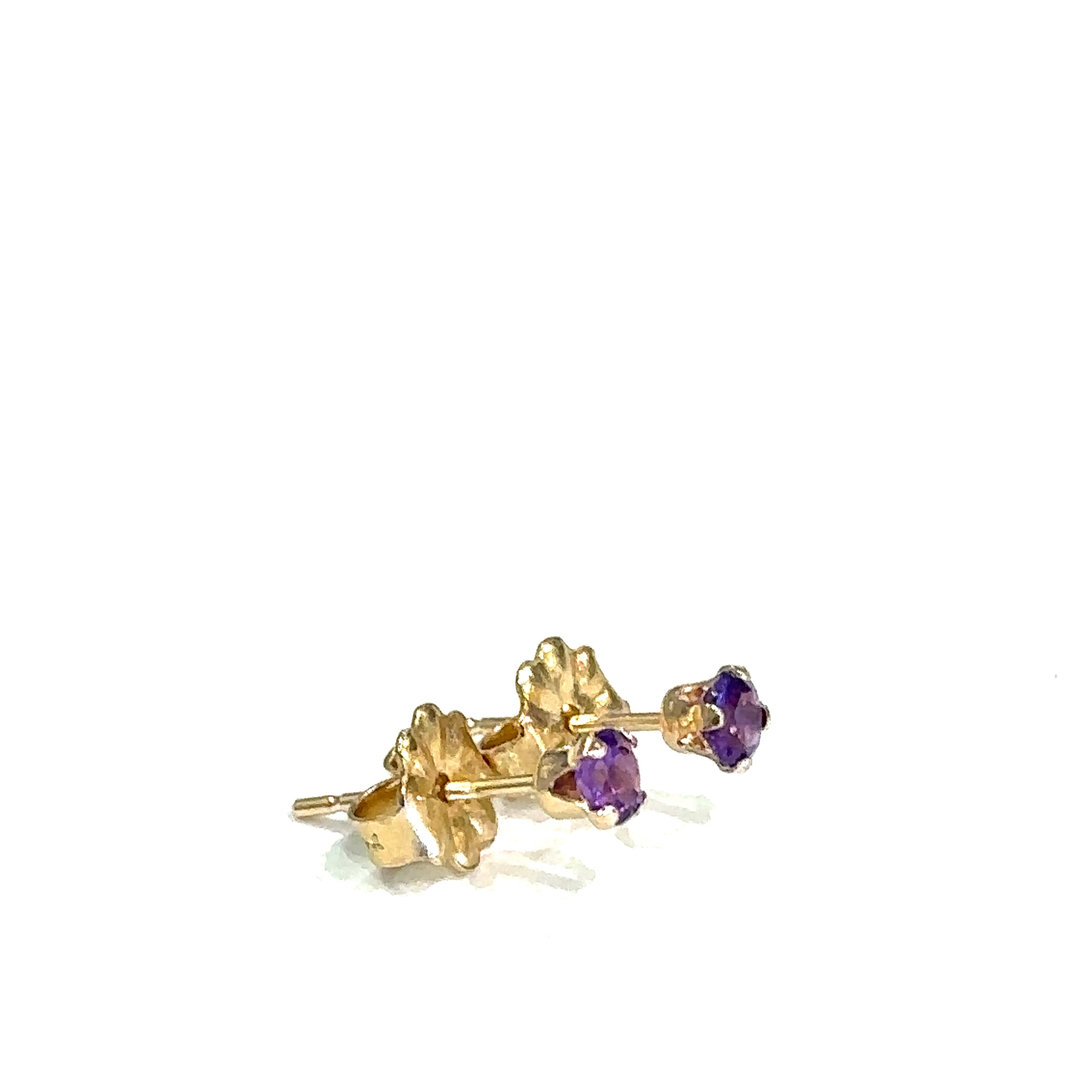 14k gold amethyst post earrings with deep purple round faceted gemstones on white background left side overview